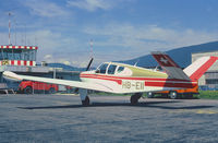 HB-EII @ LSZG - In the background the old wooden Tower at Grenchen, when all was much easier. Scanned from a slide.