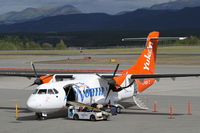 C-FVGP @ CYXY - In the ramp loading baggage at Whitehorse, YUkon - by Murray Lundberg