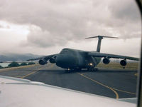 A20-624 @ KHNL - B707 Window View, showing a USAF C-5B Galaxy taxying at Hickam AFB in Honolulu, Hawaii. Photo taken from RAAF Boeing 707-338C(KC) A20-624, before a 4.4 hour flight to San Francisco KSFO on 01Sep1992. - by Walnaus47