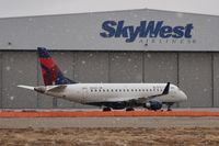 N252SY @ KBOI - Awaiting maintenance at the Skywest hanger as the snow starts to fall. - by Gerald Howard