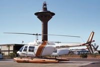 VH-PMR @ YPPD - Port side view of Vowell Port Hedland 'Port Pilots' Bell 206B JetRanger II VH-PMR Cn 358 (on fixed floats and transport trolley) on the Port Authority helipad YPPD on 27Jul1983. As VH-CSH the helo crashed near Dunedoo NSW on 22Nov2004. - by Walnaus47
