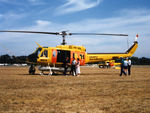 VH-NSH @ YSCB - Low res Port side view of parked NSCA Bell 205A-1 VH-NSH Cn 30195 Code 01 at Canberra Airport YSCB on 17Mar1986. This Helo is equipped with a water tank and filler hose, for Fire-fighting duties. Later Re-Regd as VH-NGK.