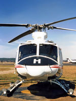 VH-AHH @ YSCB - Front view of parked Bell 412 Helicopter VH-AHH Cn 33084 Code H, photographed at Canberra Airport in Mar 1987. Note pop-out floats on the skids. (Later Regd to NSCA as VH-NSV 16JUN87 - 28MAY89.) Previously Registered as N3172D in USA.