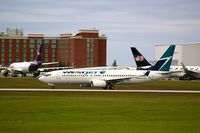 C-FZRM @ CYOW - Westjet 737-8CT departing CYOW runway 25 with a Fedex A300 and Cargojet 767 in the background - by William Halley