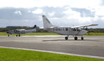 G-SCOL @ EGFH - Resident Airvan with visiting Grand Caravan G-SYLV. - by Roger Winser