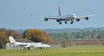 G-CMBC @ EGHH - Out engine running with 9H-EAL landing behind - by John Coates