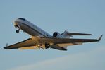 N424PX @ KAPF - The sun is so low that it lights up the underside of the wings of this departing G4 - by FerryPNL