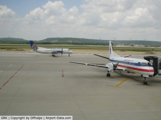 Robert Gray Aaf Airport (GRK) - A Colgan Air Saab 340 taxies to the runway for a flight to IAH, while a American Eagle Saab 340 is parked at the gate after a flight from DFW