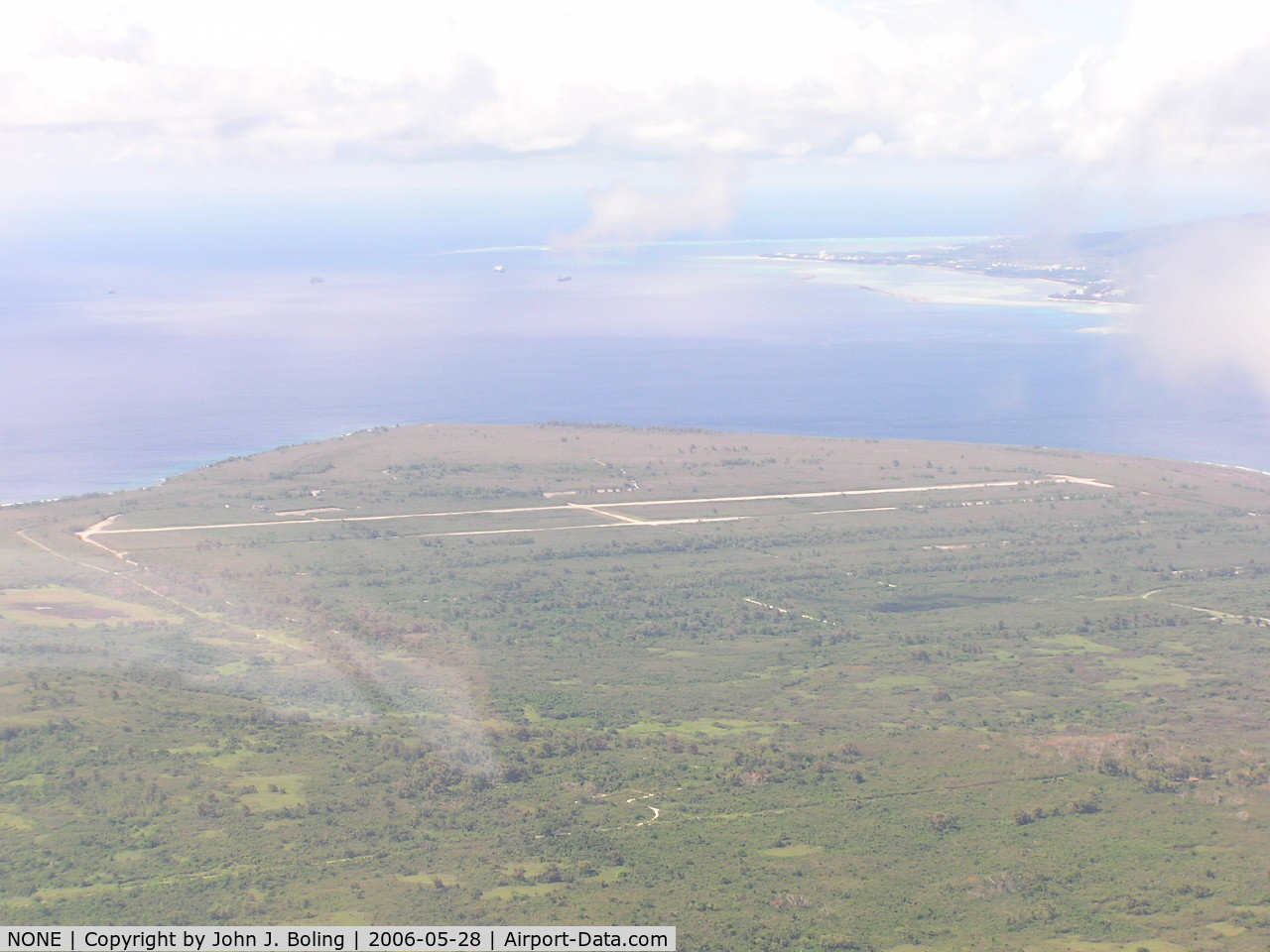 NONE Airport - Unused WW2 airfied on northern end of Tinian, Saipan in upper right of photo