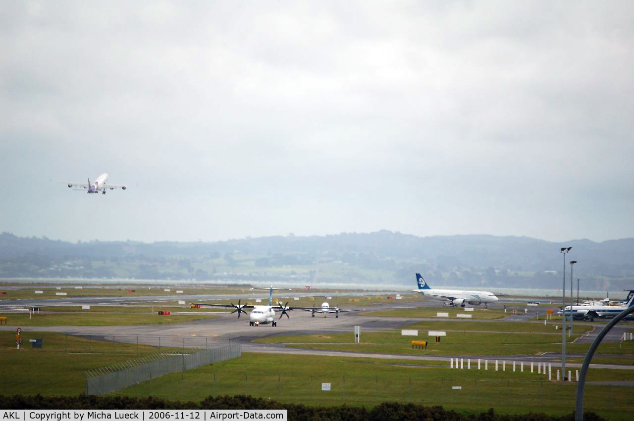 Auckland International Airport, Auckland New Zealand (AKL) - A340-600 HS-TND (Thai Airways) is climbing into the sky, while some Air NZ aircraft (ATR 72-500, Beech 1900D, A320-200) are taxiing...