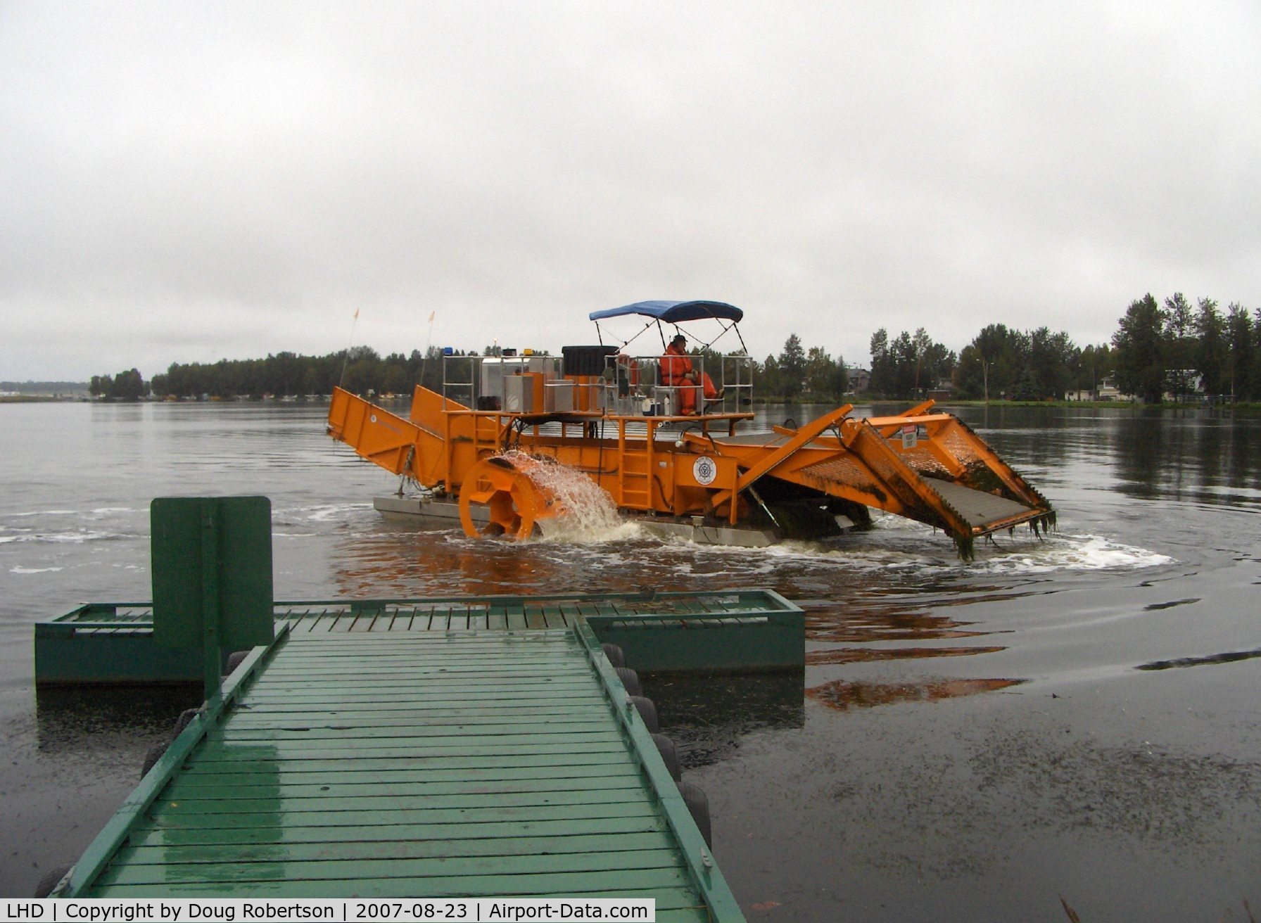 Lake Hood Seaplane Base (LHD) - Lake Hood SPB's water weed cutter/scooper keeping busy clearing taxi lanes-scooper raised