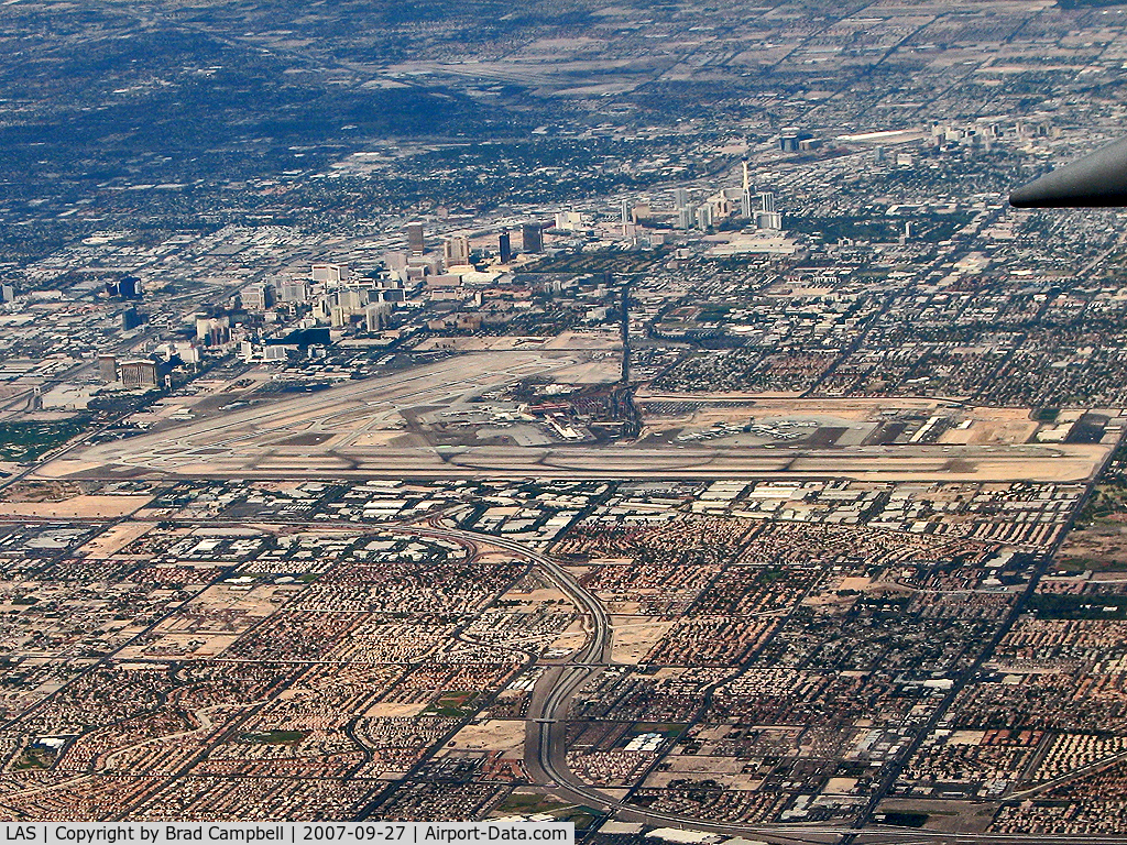 Mc Carran International Airport (LAS) - A view of McCarran while heading east. KVGT, also known as North Las Vegas Air Terminal can be seen towards center top.