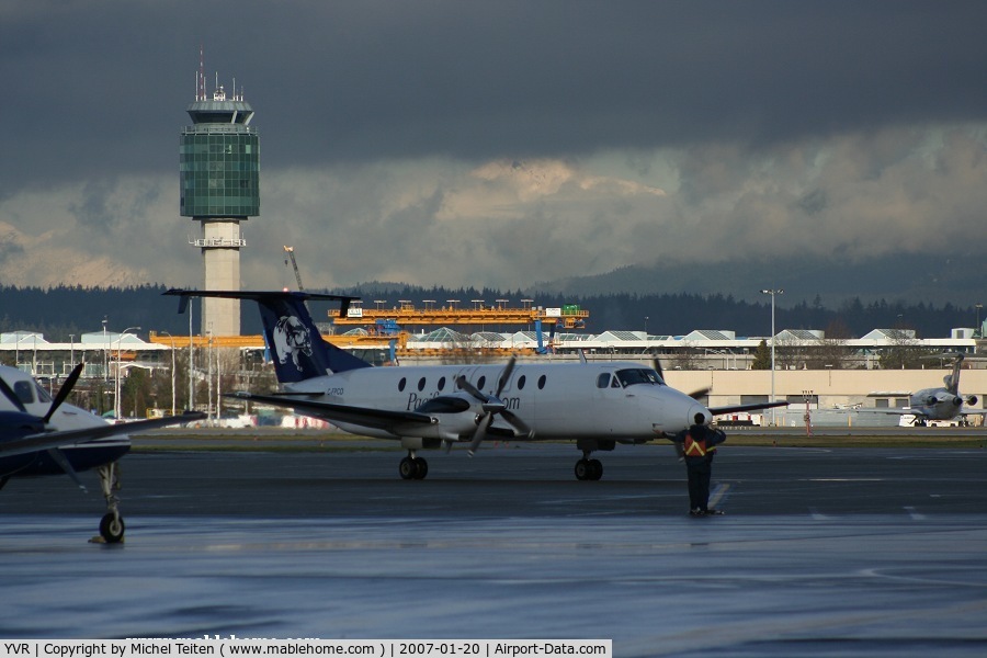 Vancouver International Airport, Vancouver, British Columbia Canada (YVR) - Winter time : Beech 1900 from Pacific Coastal at the South Terminal - Control Tower in the background