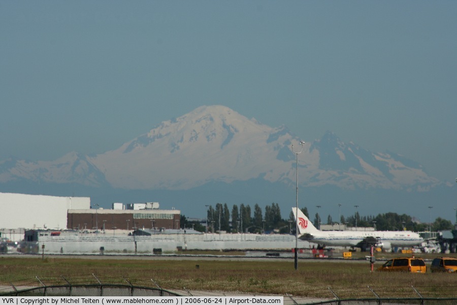 Vancouver International Airport, Vancouver, British Columbia Canada (YVR) - Mount Baker, in the Washington State can be seen over YVR (and seems closer than it actually is) with a 767 from Air China on the right