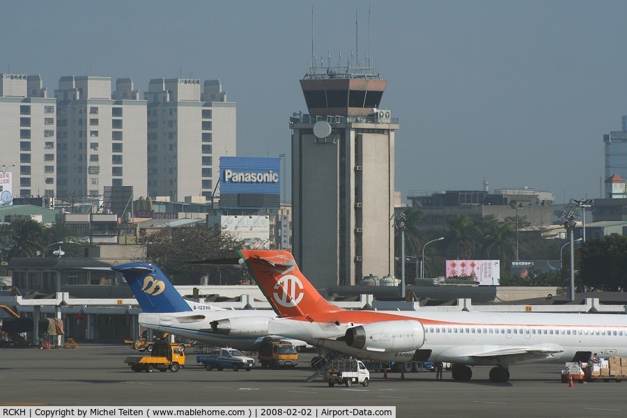 Kaohsiung International Airport, Kaohsiung City Taiwan (RCKH) - The old control tower over the domestic terminal with the tail of a F100 from Mandarin Airlines and an MD-90 from Uni Air