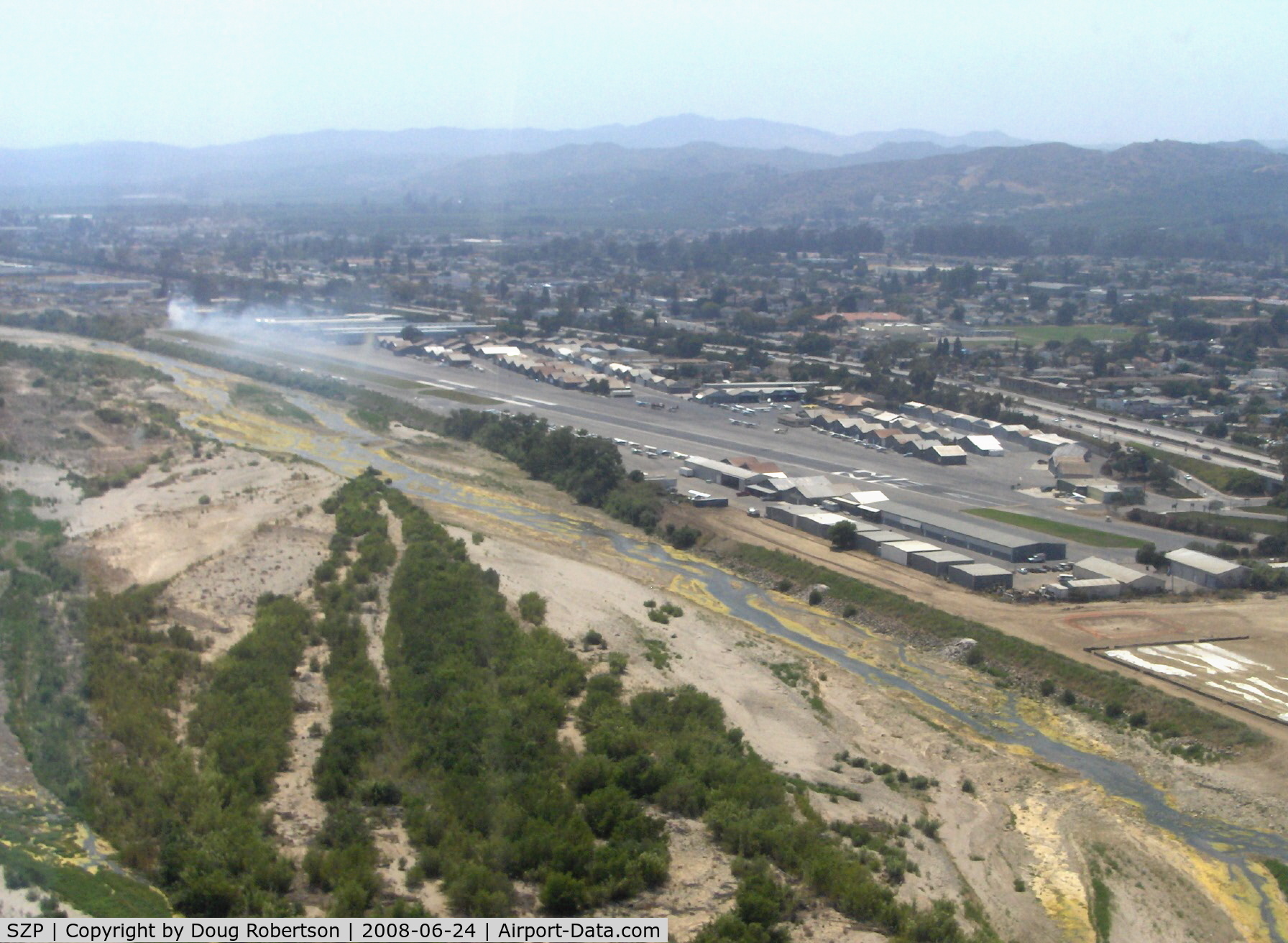 Santa Paula Airport (SZP) - Turning base for Rwy 22, off airport fire smoke in distance. Note: fire was burning brush, not an aircraft accident