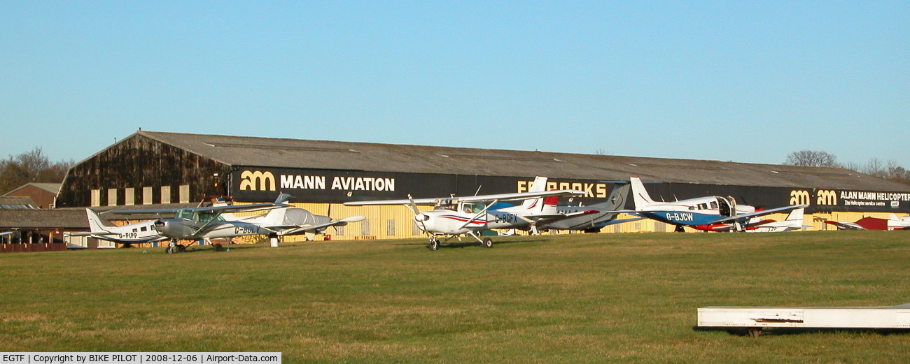 Fairoaks Airport, Chobham, England United Kingdom (EGTF) - PART OF THE AIRCRAFT PARK WITH THE ALAN MANN HANGERS IN THE BACK GROUND
