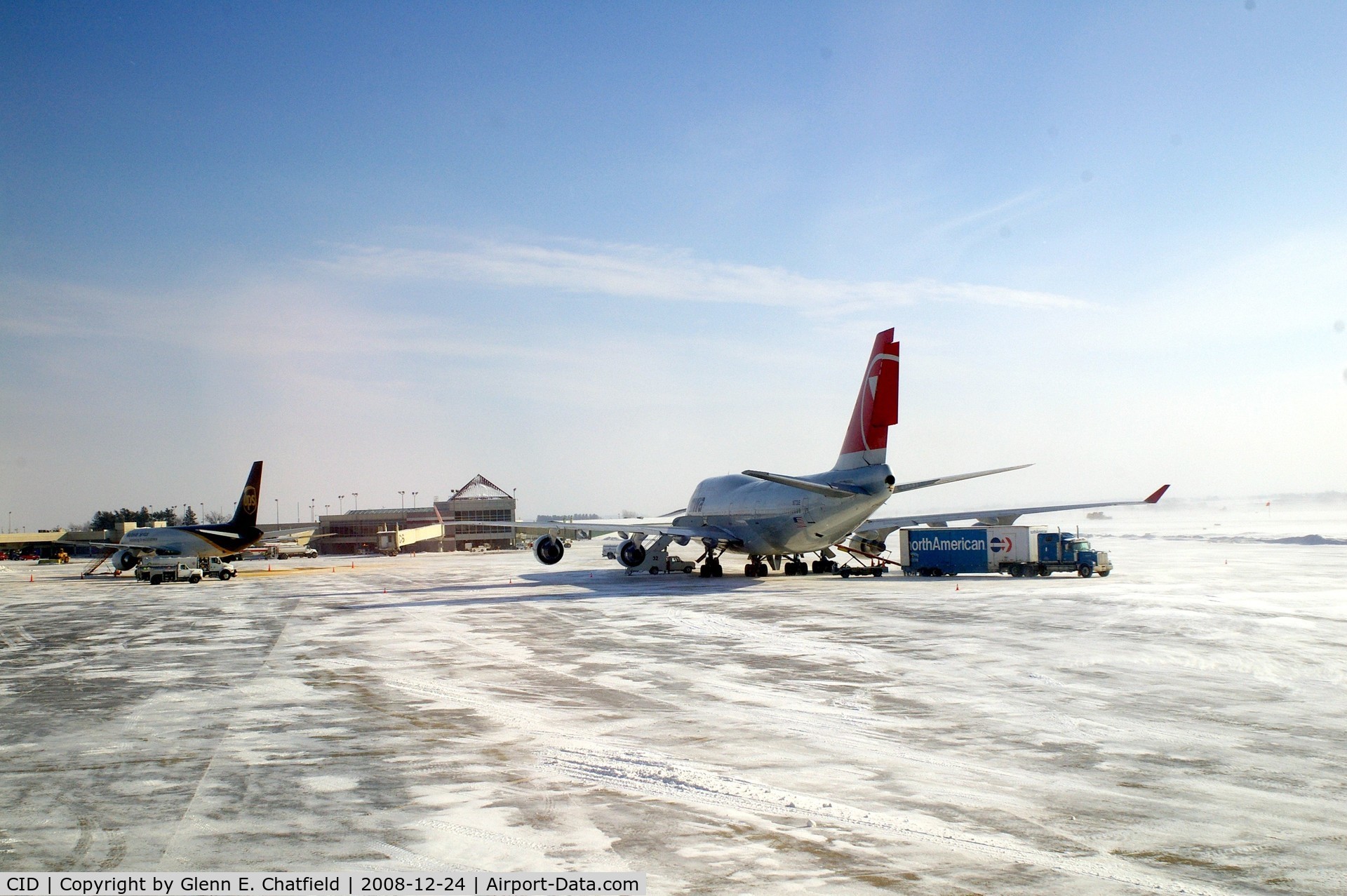 The Eastern Iowa Airport (CID) - Cold morning loading up NWA9980 with baggage from U of I football team.  10 degrees and 25-30 kt wind.  UPS 757 on the ramp