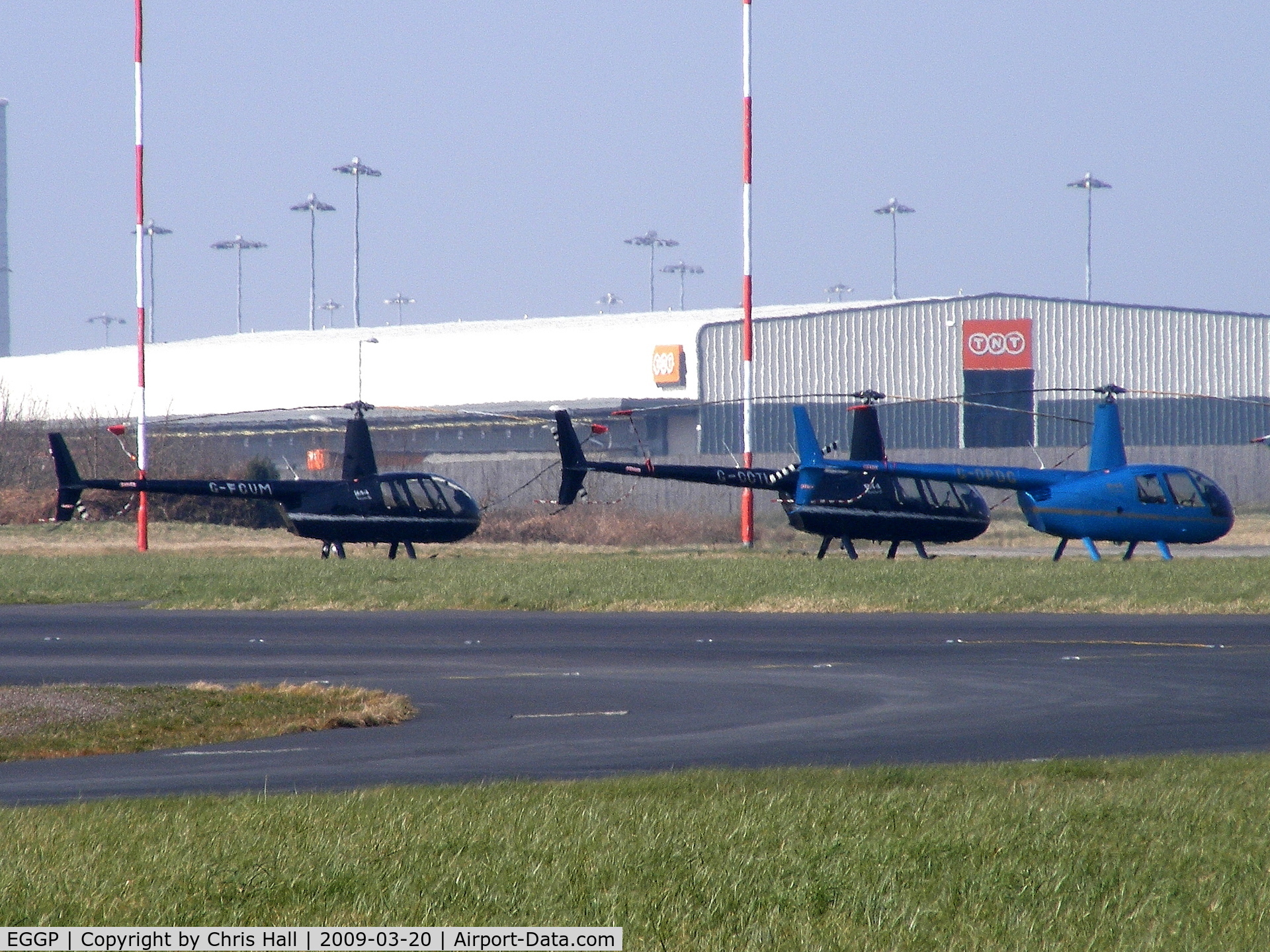 Liverpool John Lennon Airport, Liverpool, England United Kingdom (EGGP) - a lineup of Robinson R44's