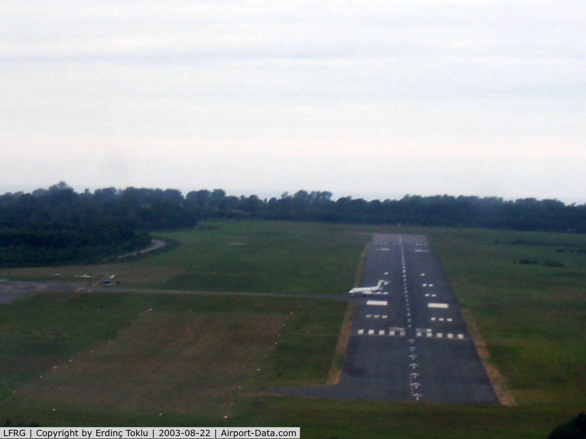 Deauville Saint-Gatien Airport, Deauville France (LFRG) - Short final Rwy 30 with a jet still on it.