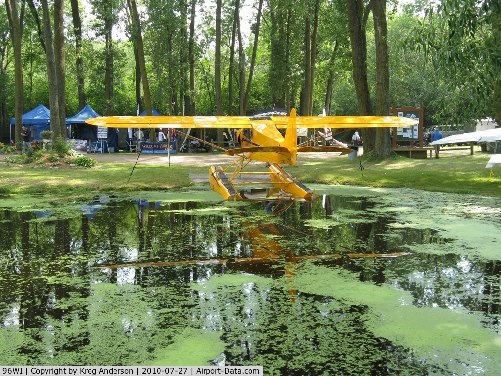 Vette/blust Seaplane Base (96WI) - A view of a Cub and some exhibitors behind it at the Vette/Blust Seaplane Base.
