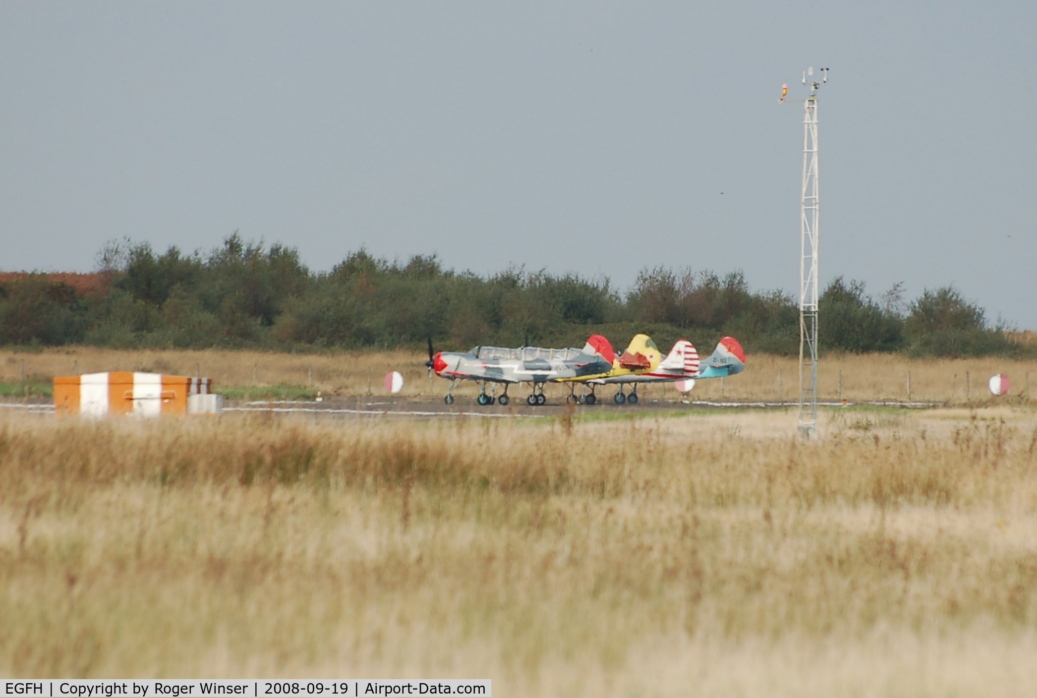 Swansea Airport, Swansea, Wales United Kingdom (EGFH) - Four Yak-52's preparing to depart Runway 22 for formation practice.