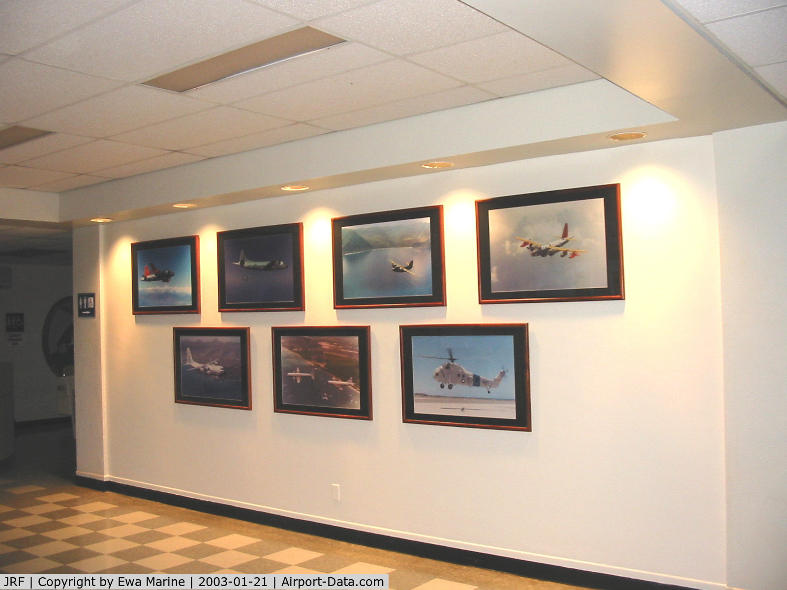 Kalaeloa (john Rodgers Field) Airport (JRF) - Hawaiian Aviation Preservation Society (HAPS) members work after revamping tower lobby with historic pictures of the airports past aircraft