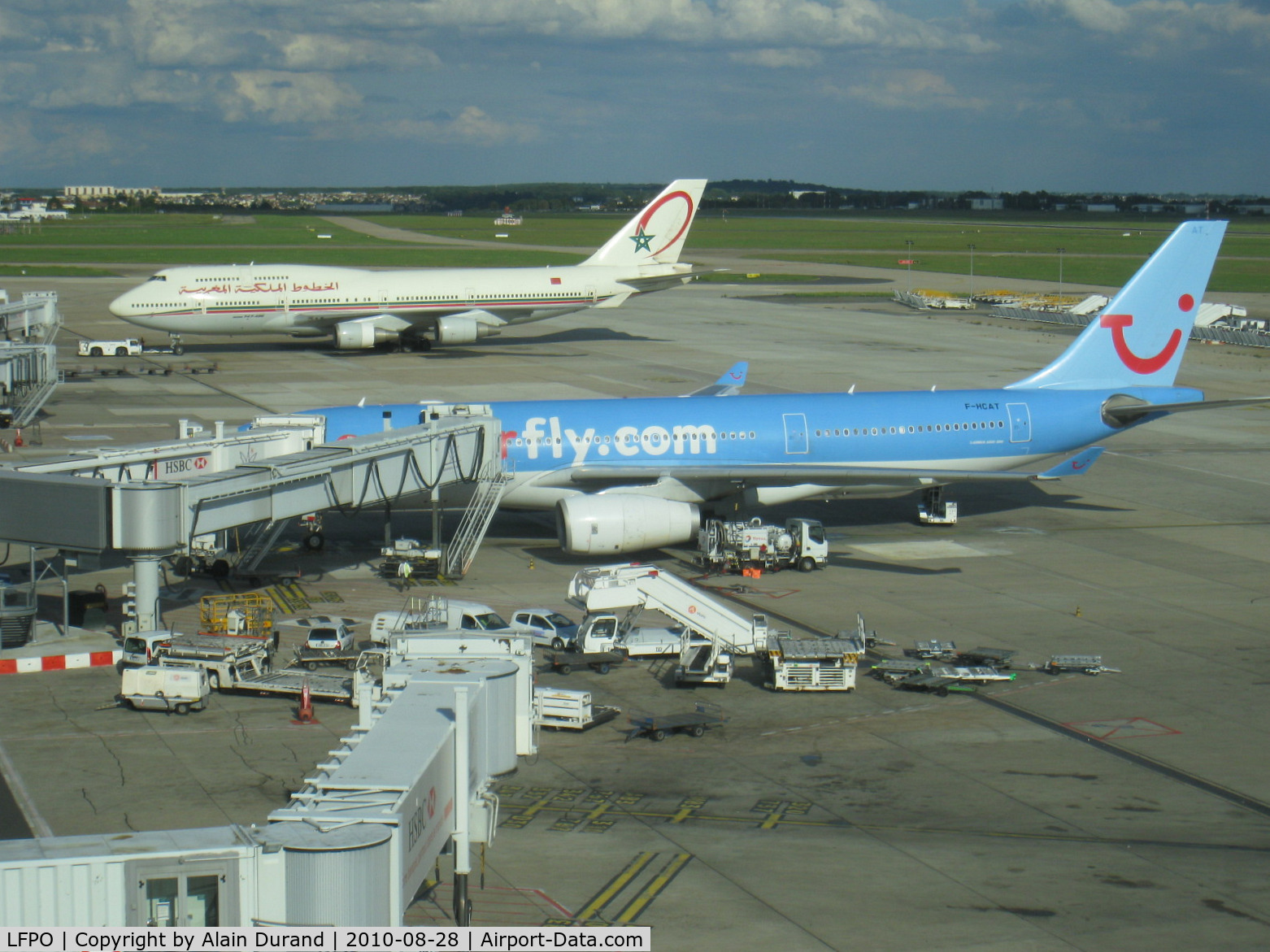 Paris Orly Airport, Orly (near Paris) France (LFPO) - Part view on the southeastern side from the observation deck of South terminal. Royal Air Maroc 747-428 CN-RGA was on push-back while Corsairfly A330-243 F-HCAT was being serviced in anticipation of a return to Miami