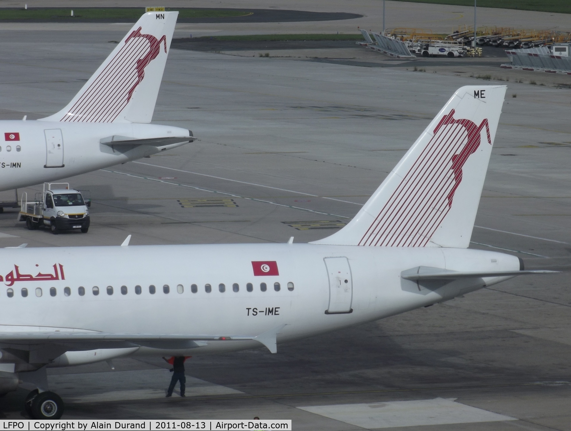 Paris Orly Airport, Orly (near Paris) France (LFPO) - Tale of two tails. Tunisair A320 TS-IME had just docked to gate as TU 722 from Tunis. Sister-ship Mike-November was being serviced in anticipation of her return to Djerba