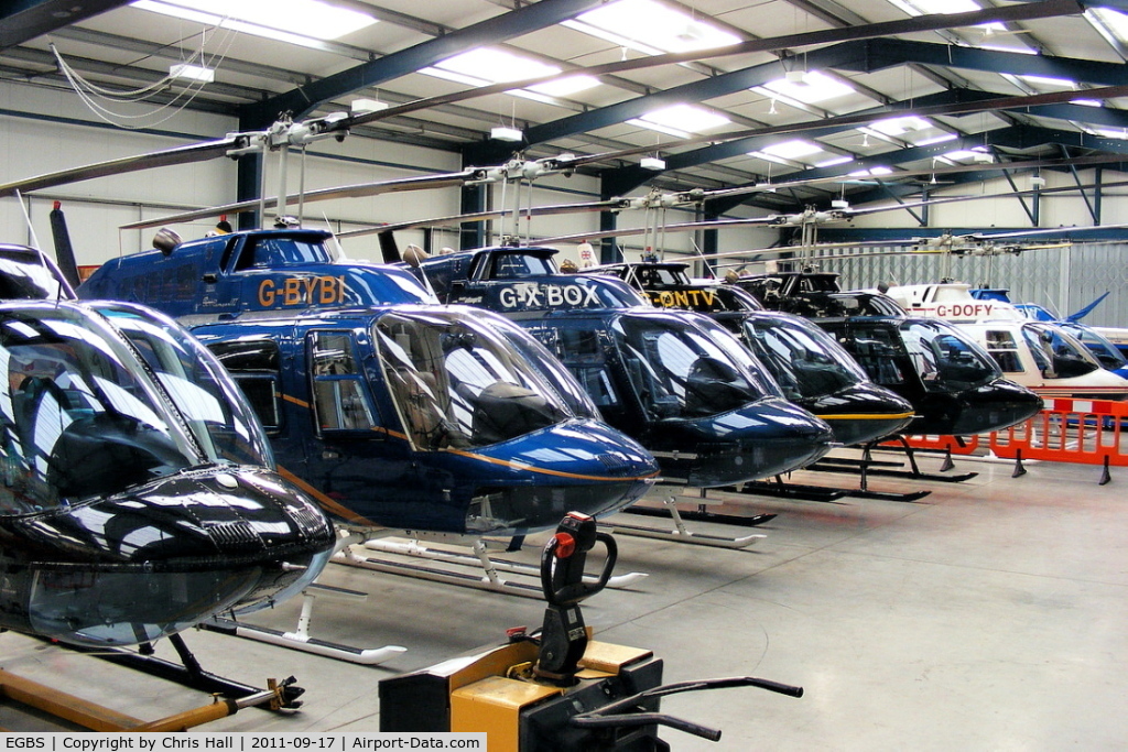 Shobdon Aerodrome Airport, Leominster, England United Kingdom (EGBS) - lineup of Bell 206 Jetrangers in the Tiger Helicopter's hangar at Shobdon. From L to R, G-OMDR, G-BYBI, G-XBOX, G-ONTV, G-SPEY, G-DOFY, G-BSBW. 