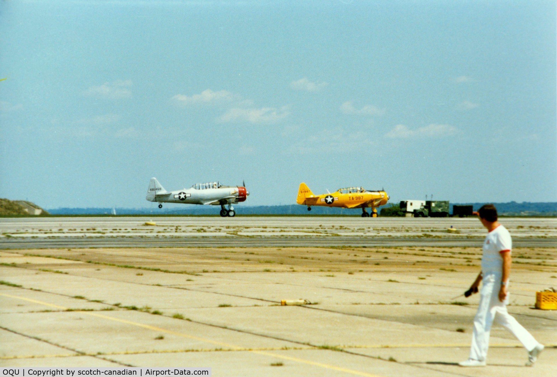 Quonset State Airport (OQU) - North America AT-6 Texan N6984C and North American AT-6 Texan 51-14987 at Quonset State Airport, North Kingstown, RI - circa 1980's