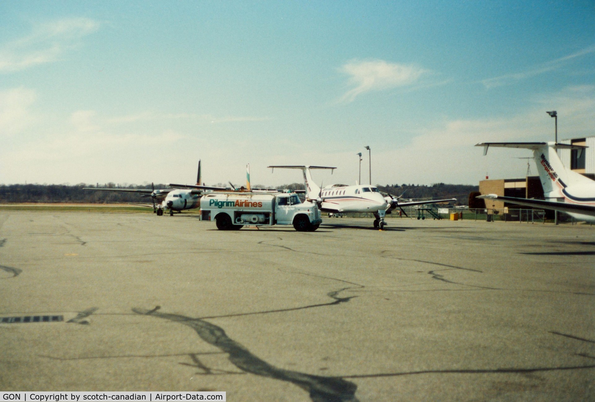 Groton-new London Airport (GON) - Pilgrim Airlines Fokker F27's, Fuel Truck and Business Express Airlines Beech 1900's at Groton-New London Airport, New London, CT - circa 1980's