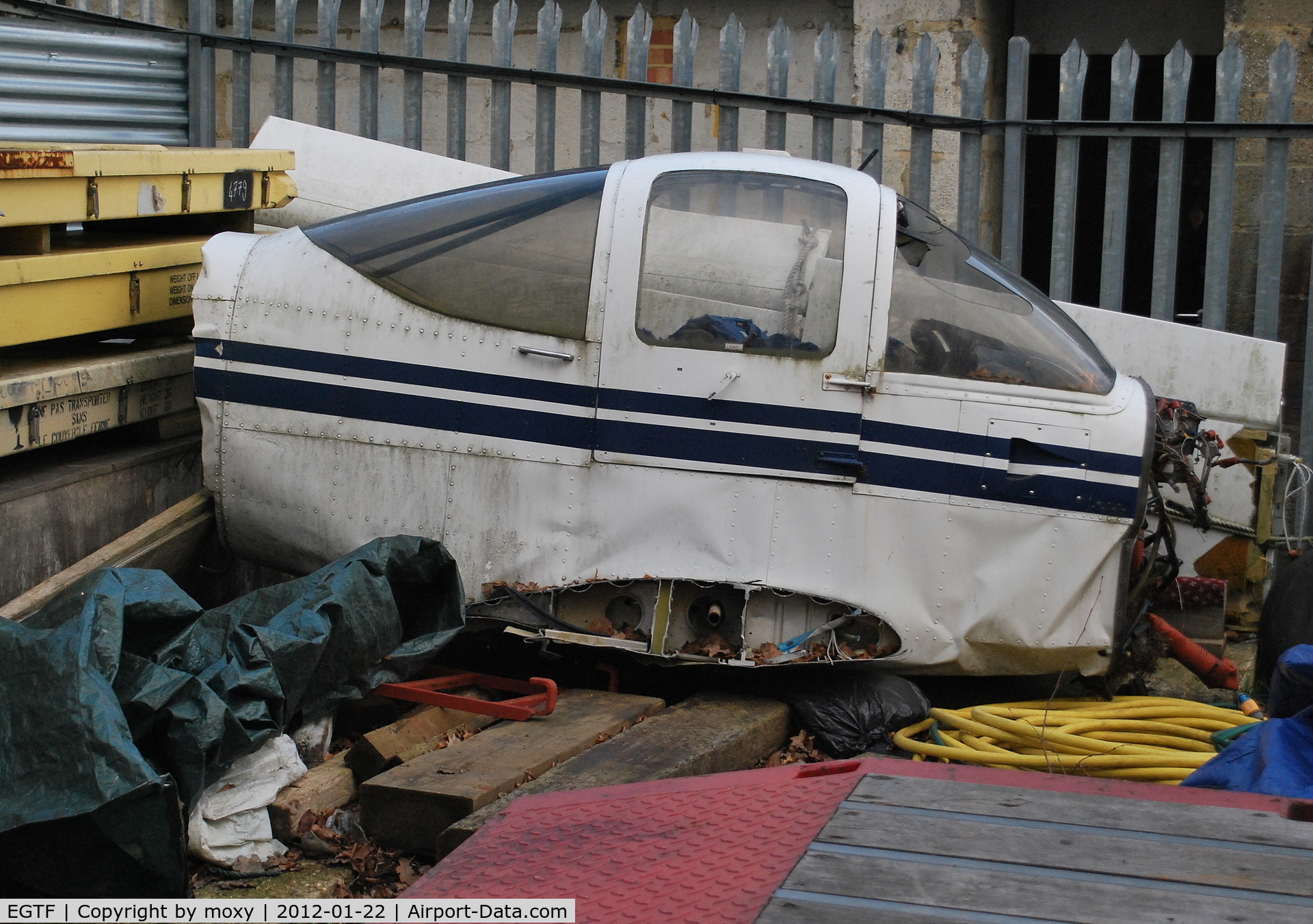 Fairoaks Airport, Chobham, England United Kingdom (EGTF) - Unidentified PA-38 Tomahawk section in the compound at Fairoaks. The wings behind are from Cirrus SR22 G-TAAA which crashed at Denham.