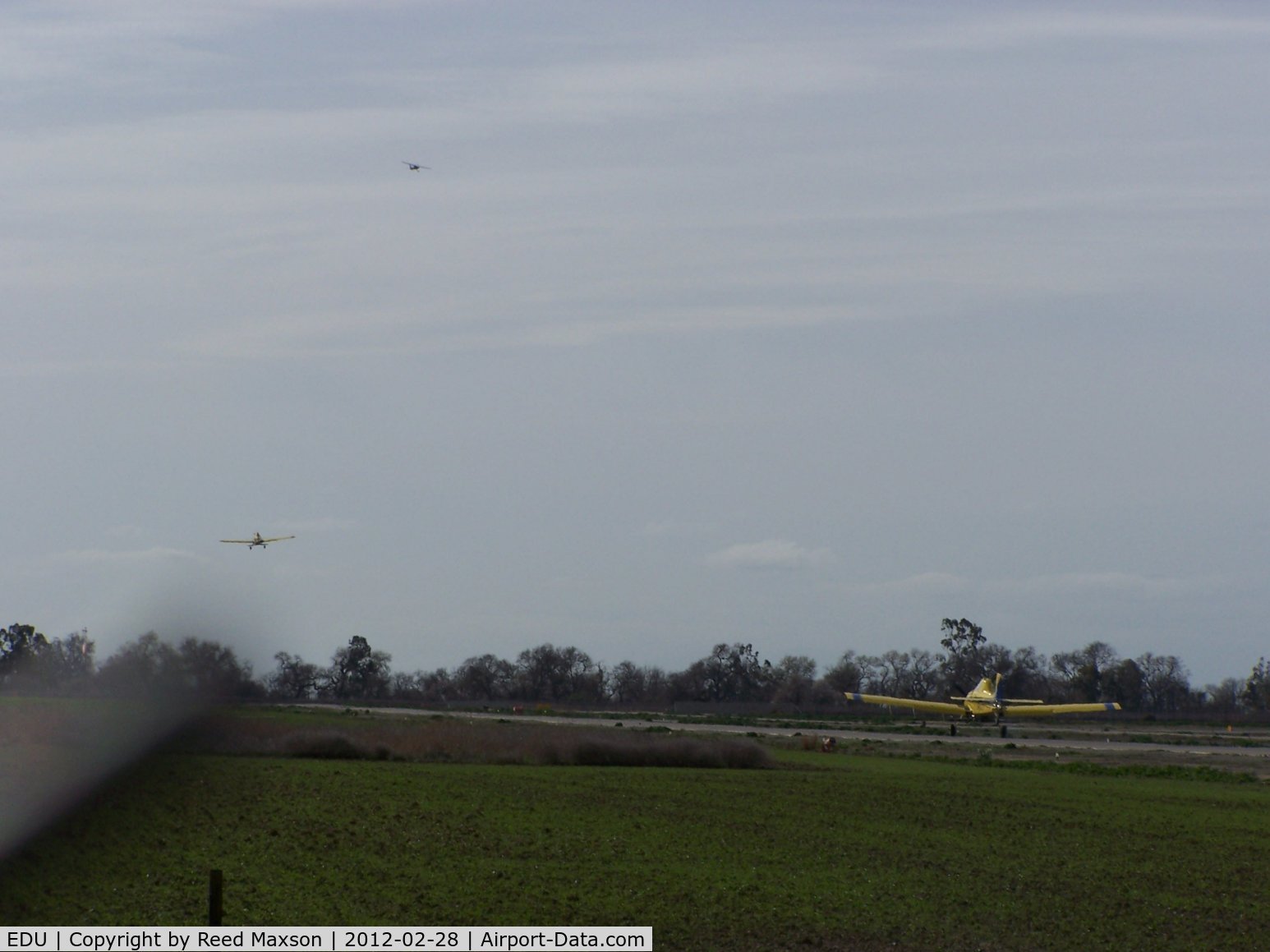 University Airport (EDU) - Looking south, a Cessna 152 and an Air Tractor departing from 17, an Air Tractor arriving.  As busy as KJFK, and no ATC!