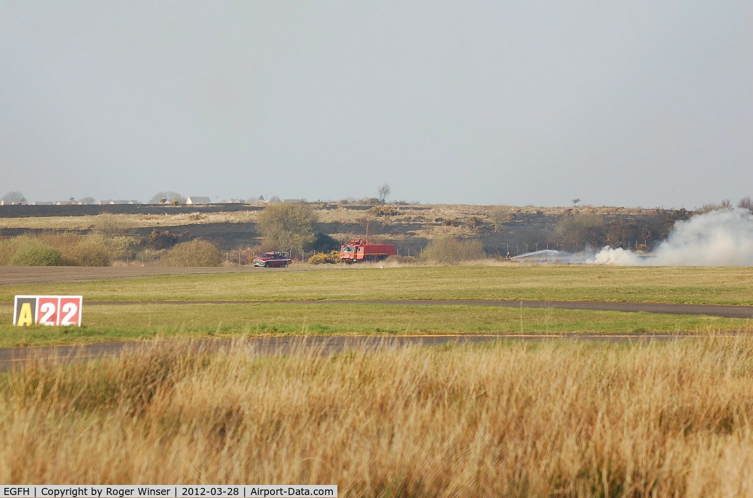 Swansea Airport, Swansea, Wales United Kingdom (EGFH) - Airport Fire and Rescue Services FIRE 1 and FIRE 2 tackle a blaze on the perimiter of the airfield.