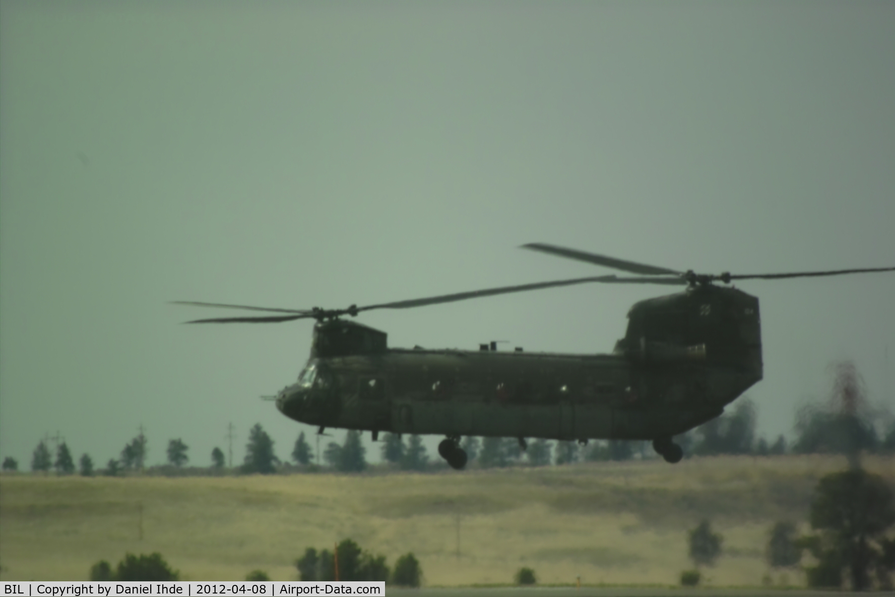 Billings Logan International Airport (BIL) - The chinook with number 124 hovering while another chinook taxi's to park @ KBIL.