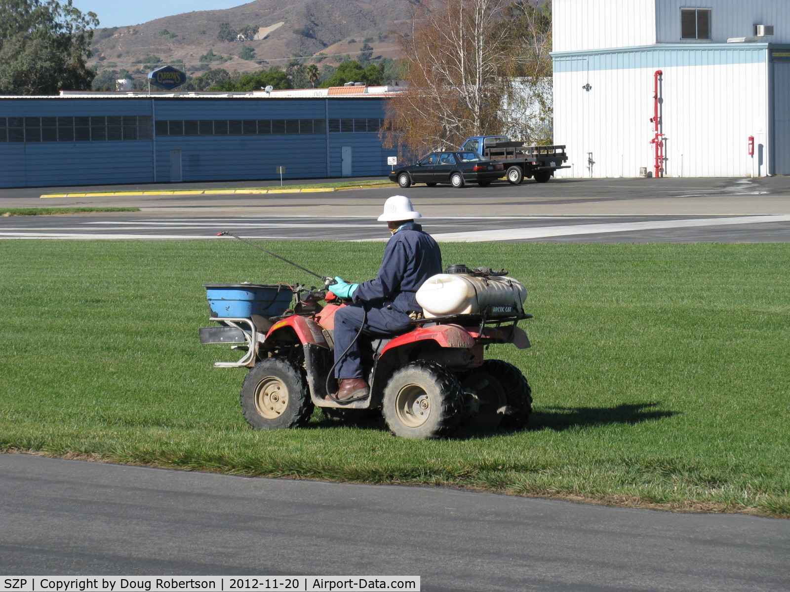 Santa Paula Airport (SZP) - Slow commercial spraying with extended hand nozzle-Rwy 22L grass. Breathing mask, gloves worn.