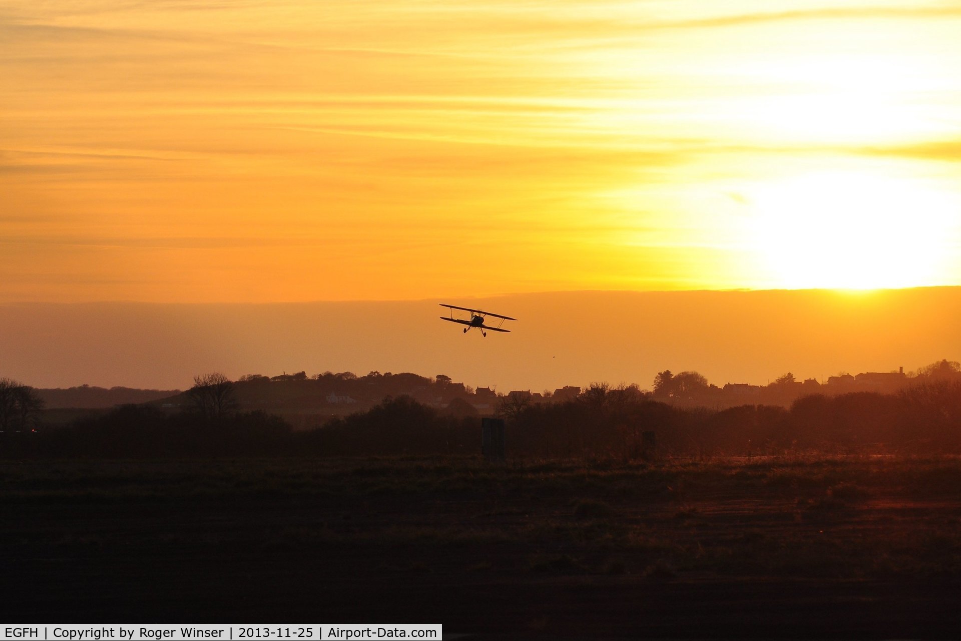 Swansea Airport, Swansea, Wales United Kingdom (EGFH) - Biplane arriving at sunset.