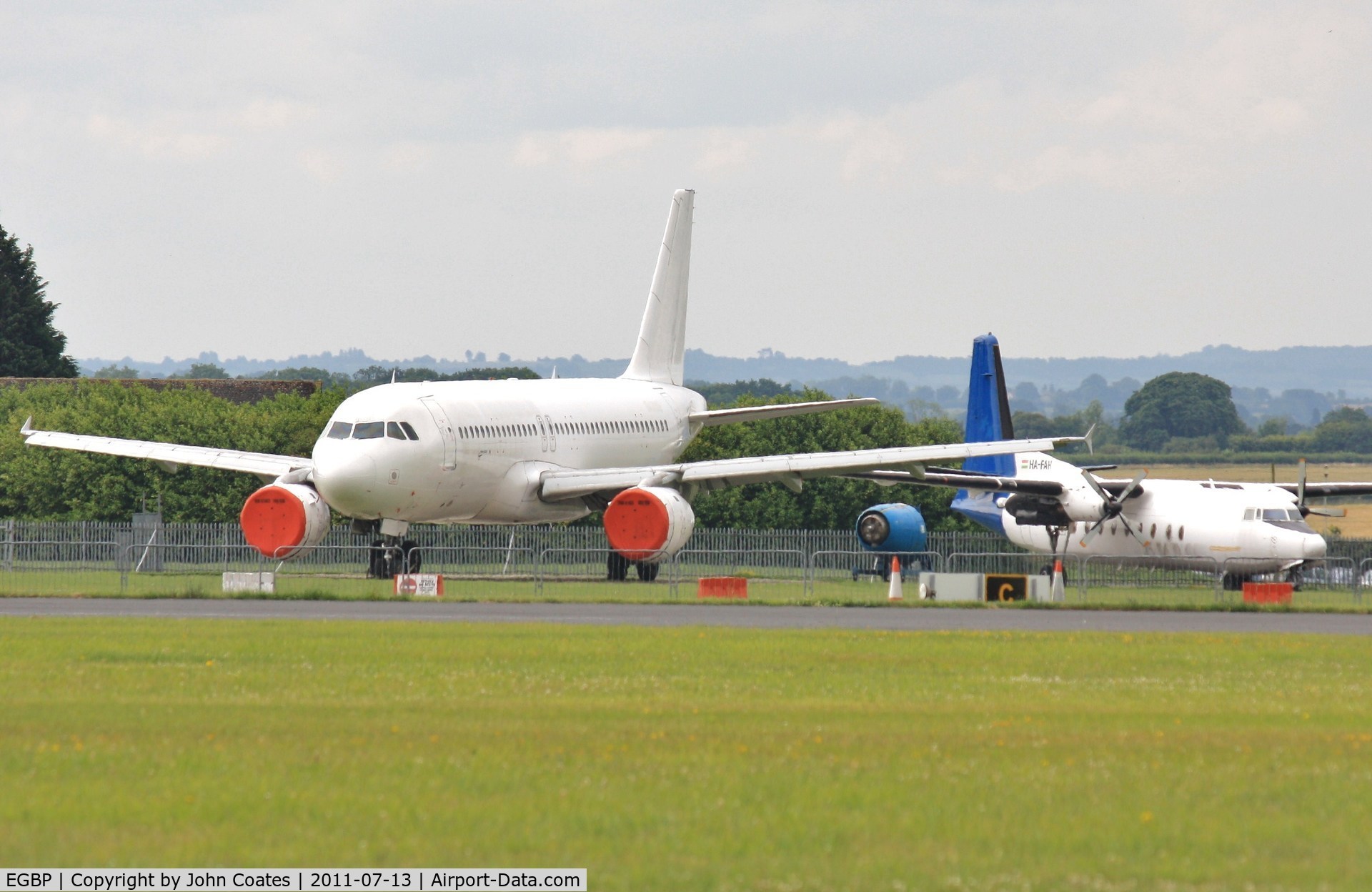 Kemble Airport, Kemble, England United Kingdom (EGBP) - Storage area with HA-FAH and un-reg'd A320