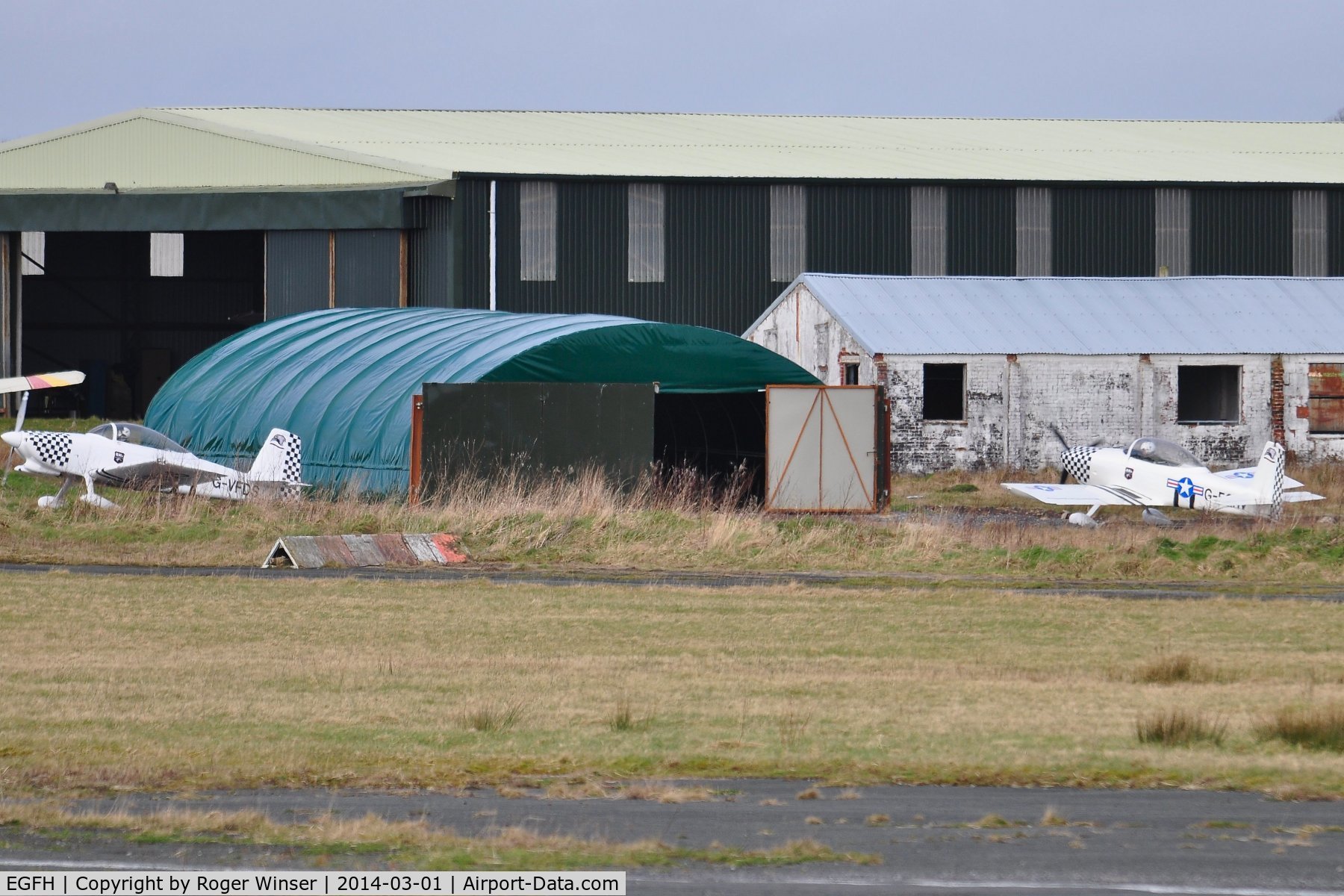 Swansea Airport, Swansea, Wales United Kingdom (EGFH) - Recently erected hangar to house Vans aircraft including two RV-8's of Team Raven formation aerobatic team. G-VFDS and G-EGRV can be seen outside the hangar.