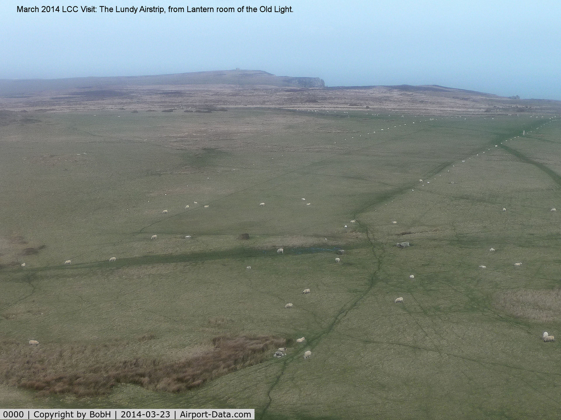 0000 Airport - The Airstrip on Lundy Island. The width is marked with white painted stones. 99% of the time a strong westerly blows and here you are looking East. The other white objects are sheep! Approach very carefully. Lundy is 11 miles off North Devon Coast.
