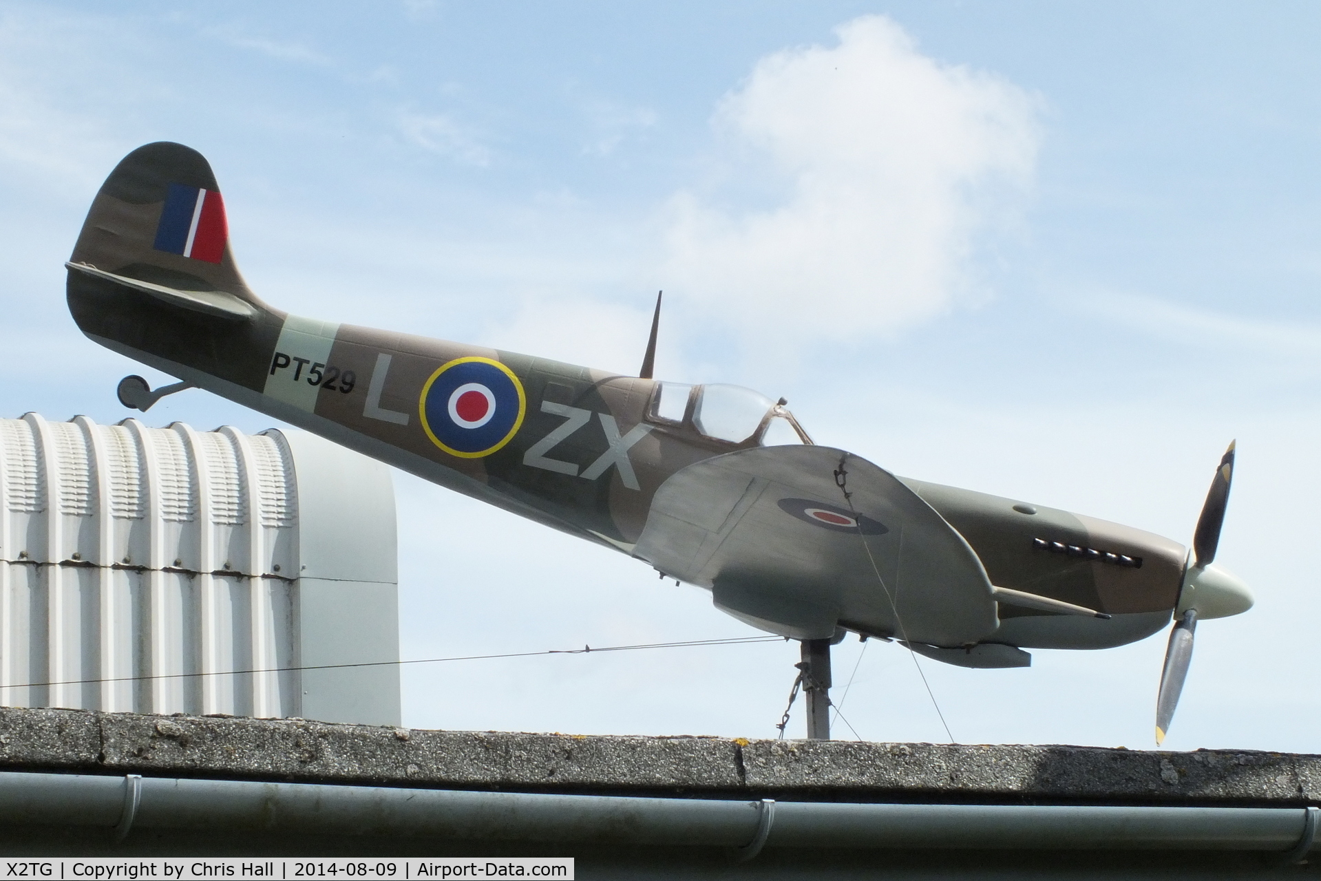 X2TG Airport - large scale model Spitfire on the roof of the Tangmere Military Aviation Museum