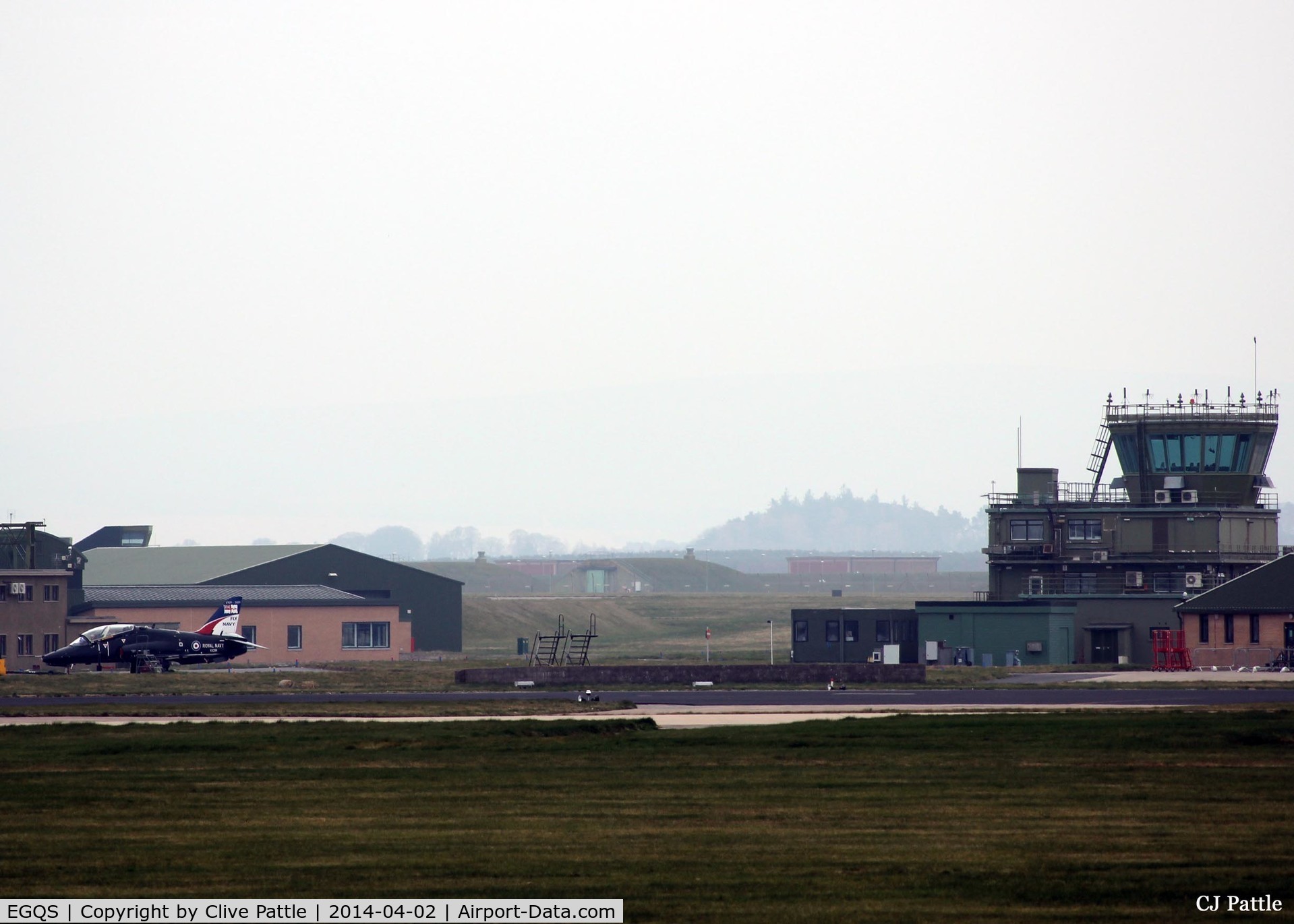 RAF Lossiemouth Airport, Lossiemouth, Scotland United Kingdom (EGQS) - Shot of the tower on a dull, misty and overcast morning at RAF Lossiemouth. A visiting Royal Navy Hawk T.1 sits awaiting its next sortie during the ongoing Exercise Joint Warrior 14-2