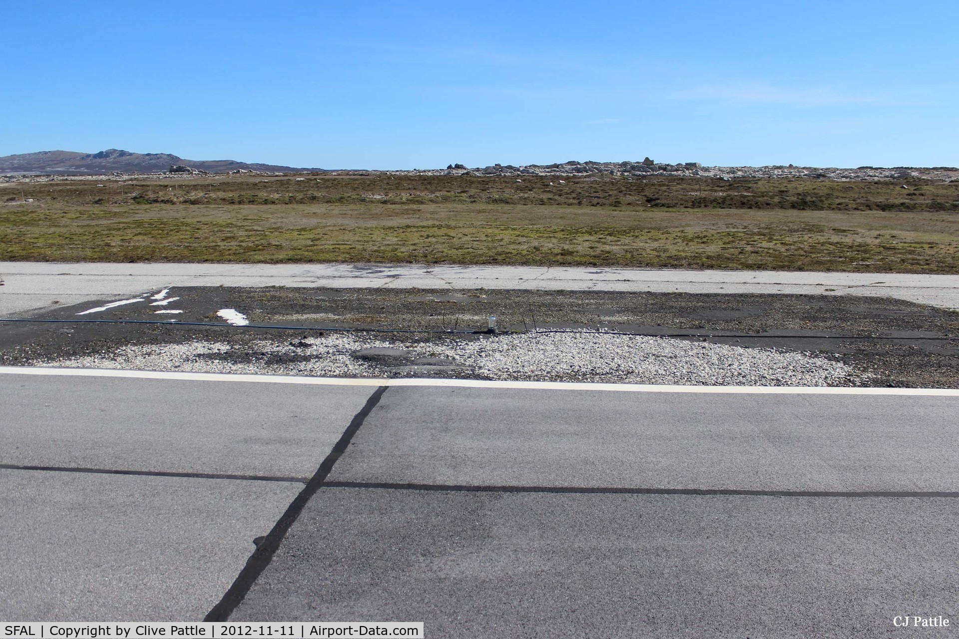 SFAL Airport - A darkened area of tarmac on the edge of the main runway at Port Stanley (SFAL) shows where repairs were made following the Vulcan Black Buck bombing sortie in May 1982. 