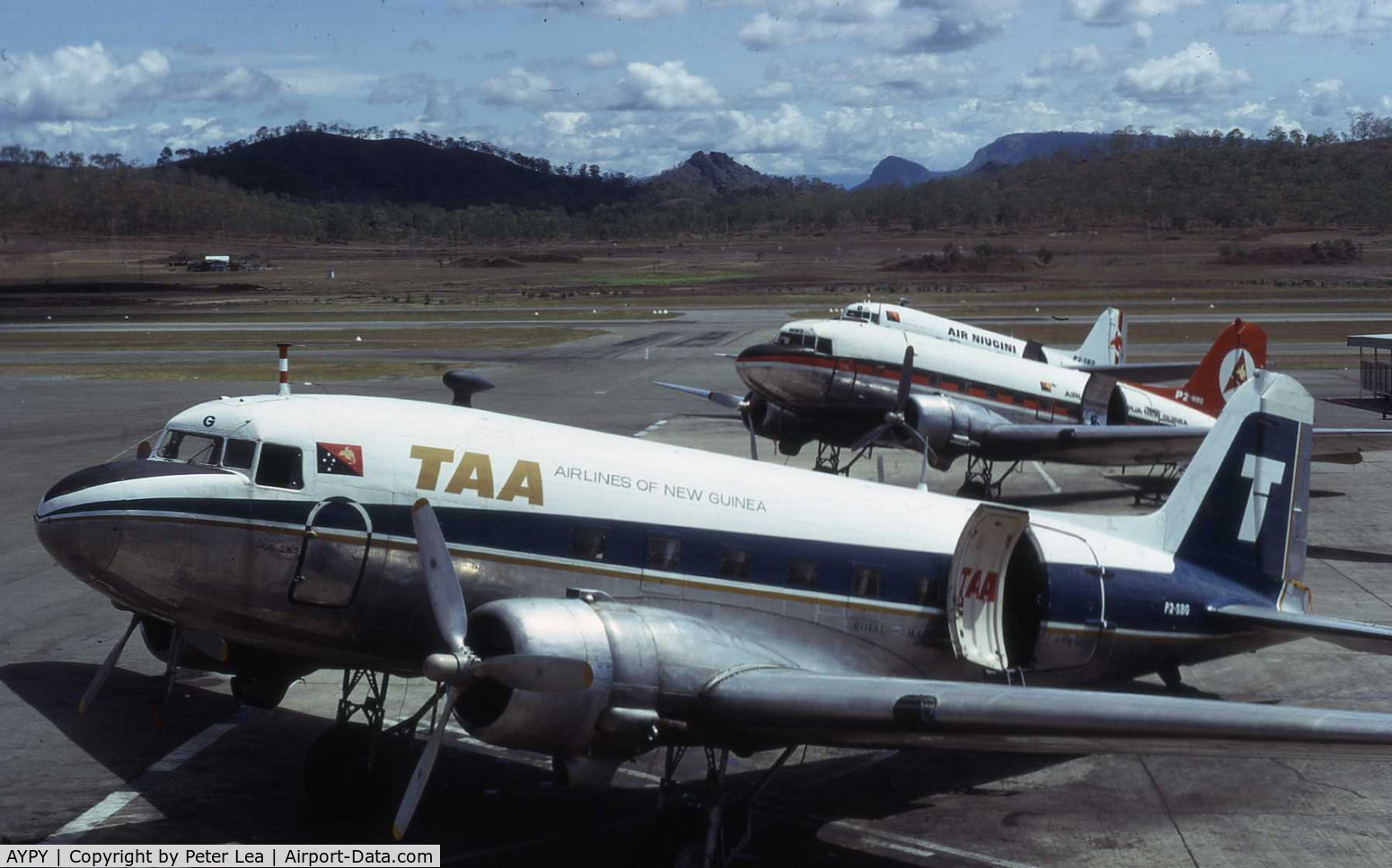 Port Moresby/Jackson International Airport, Port Moresby Papua New Guinea (AYPY) - A trio of Douglas DC-3's at Port Moresby Airport, each in a different color scheme. This was the transition period for the newly formed Air Nuigini. Photo taken December 1974