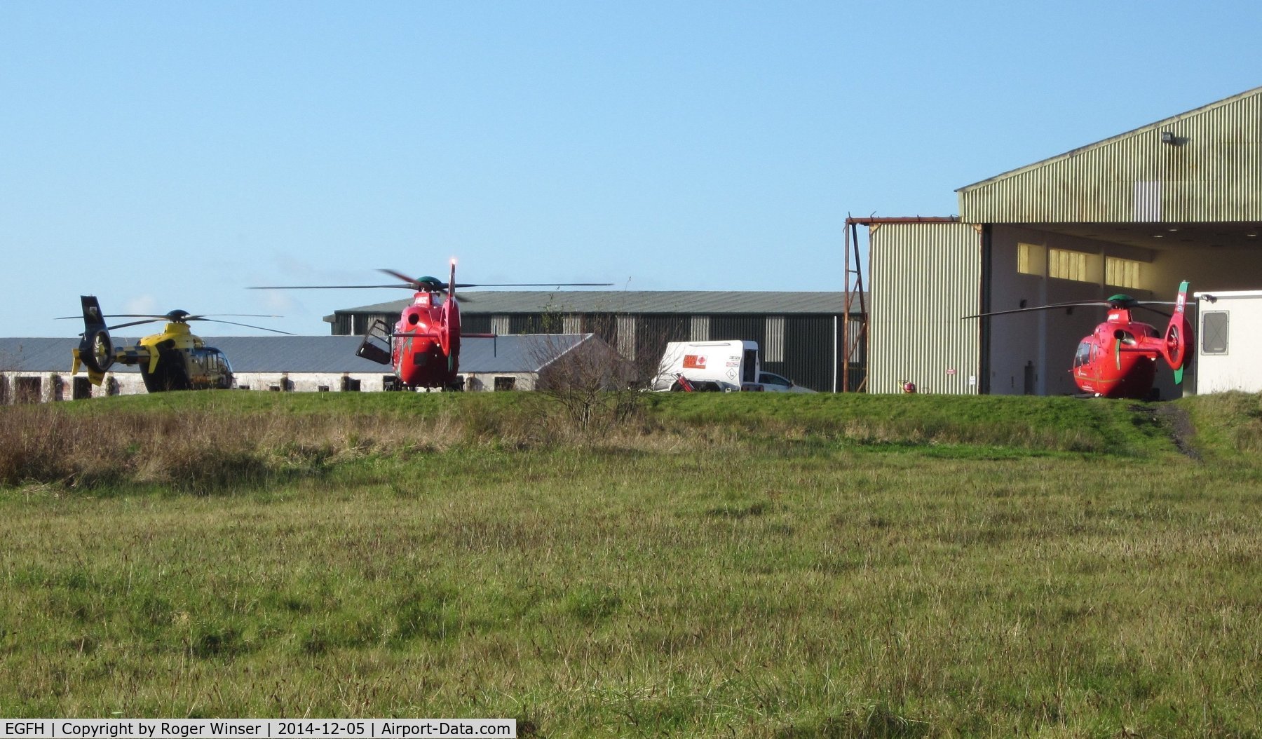 Swansea Airport, Swansea, Wales United Kingdom (EGFH) - A police and two air ambulance emergency services helicopters on the apron by the Wales Air Ambulance base at Hangar 1.