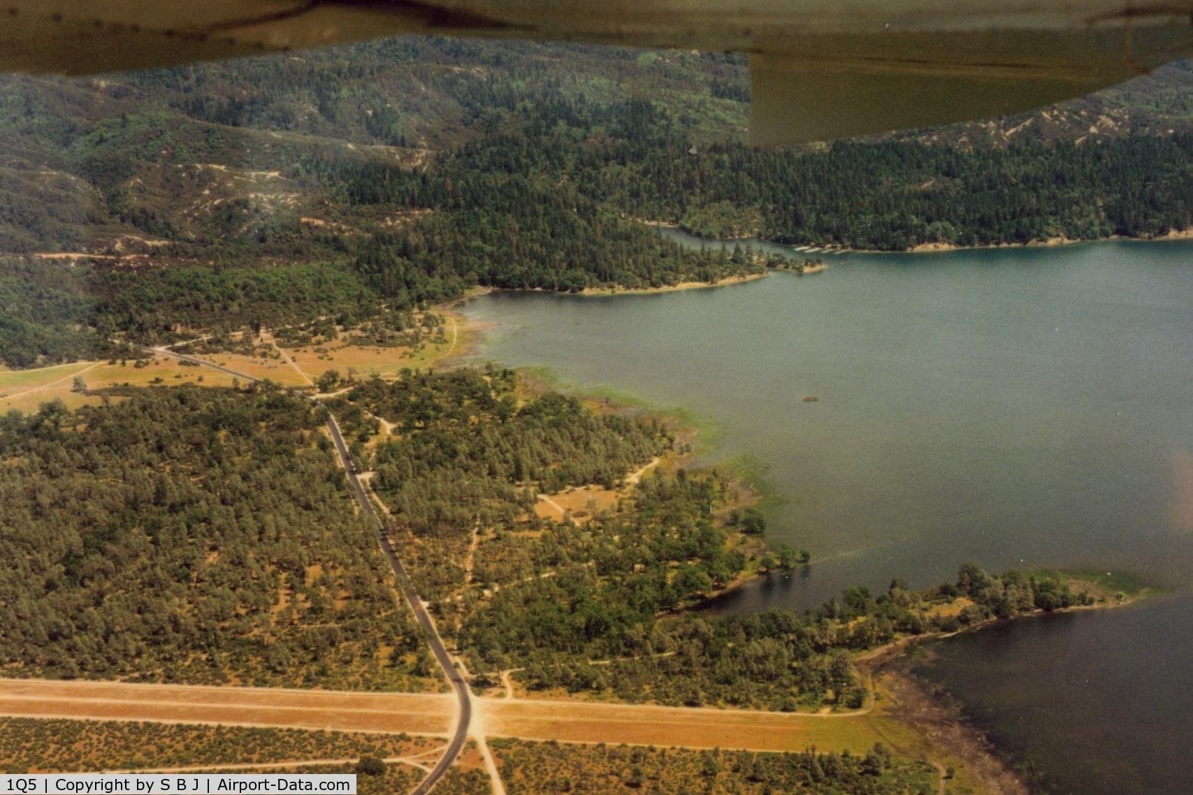 Gravelly Valley Airport (1Q5) - This picture shows the road that crosses the south end of runway.While there are stop signs,vehicles do not always stop.Landing, a pilot should be prepared for this!!Seen more then one pilot startled when a car appeared when landing.