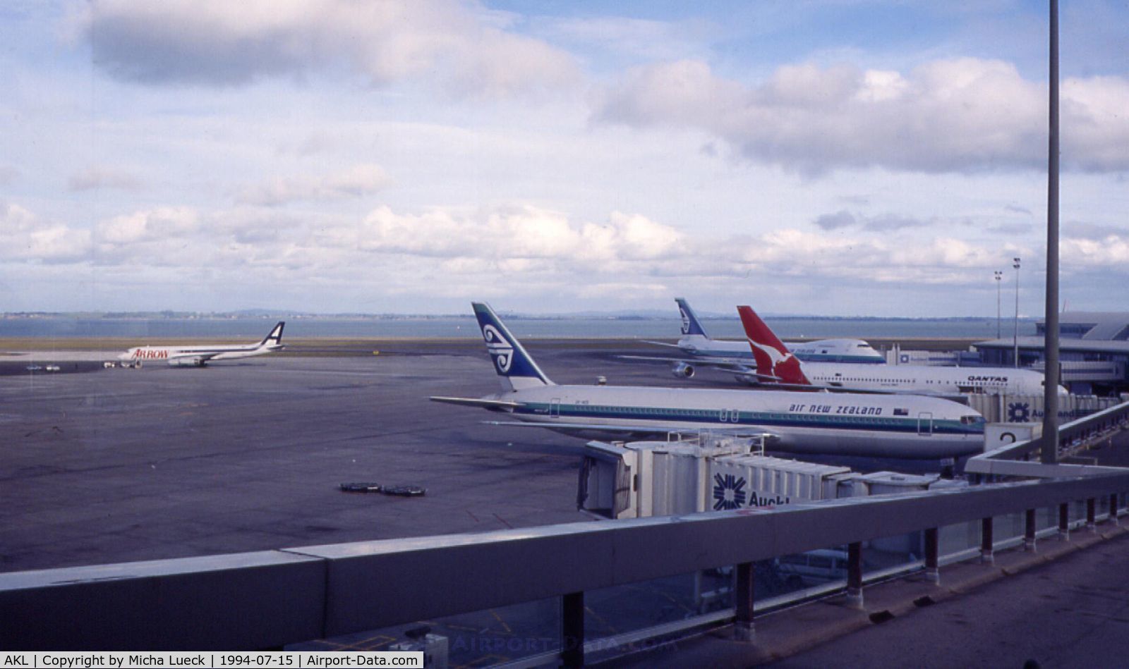 Auckland International Airport, Auckland New Zealand (AKL) - Nice shot of the apron at Auckland: Arrow's good old DC8, a B767-300 and a B747-200 in Air NZ's old livery, and a Qantas B767-200
