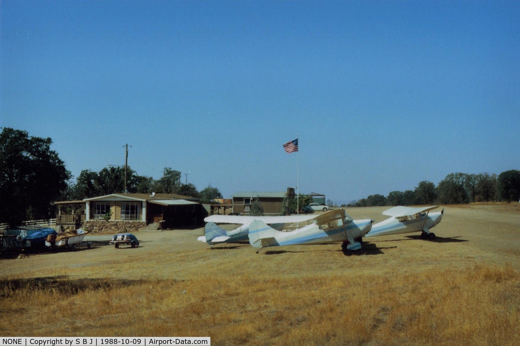 NONE Airport - Robbins Airport near  Lake Comanche,Ca.is a private strip.View is to the west and the 1st annual Chief ( and only one) fly in in progress.If open to the public (its not) the 1500 foot runway might need a net at the end to catch sunday pilots.