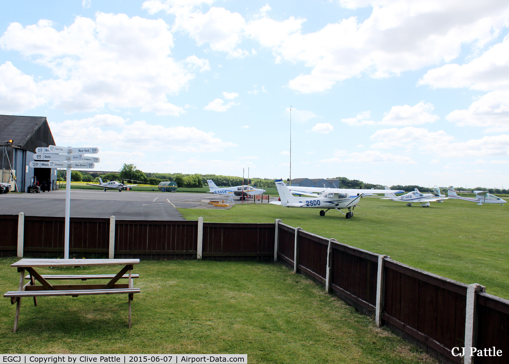 Sherburn-in-Elmet Airfield Airport, Sherburn-in-Elmet, England United Kingdom (EGCJ) - Looking across the apron from the clubhouse of Sherburn Aero Club. The staff are very welcoming and the food is de-lish. If you ask nicely and have a Hi-Vis jacket you may get airside and hangar access.
